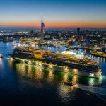 AIDASol cruise ship sails into Portsmouth harbour at dawn