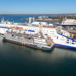 The Saint-Malo sits alongside one of Portsmouth International Port's berths, while a smaller grey ship, the Optimus, sits next to her during the bunkering process