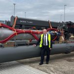 Maritime minister Mike Kane stood in front of shore power equipment